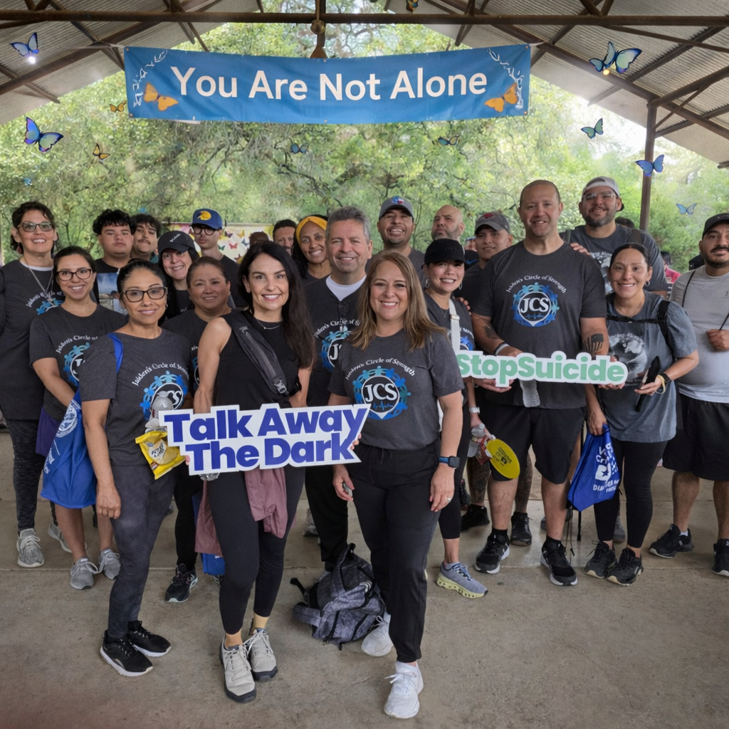 Group photo under 'You Are Not Alone' banner at a community walk