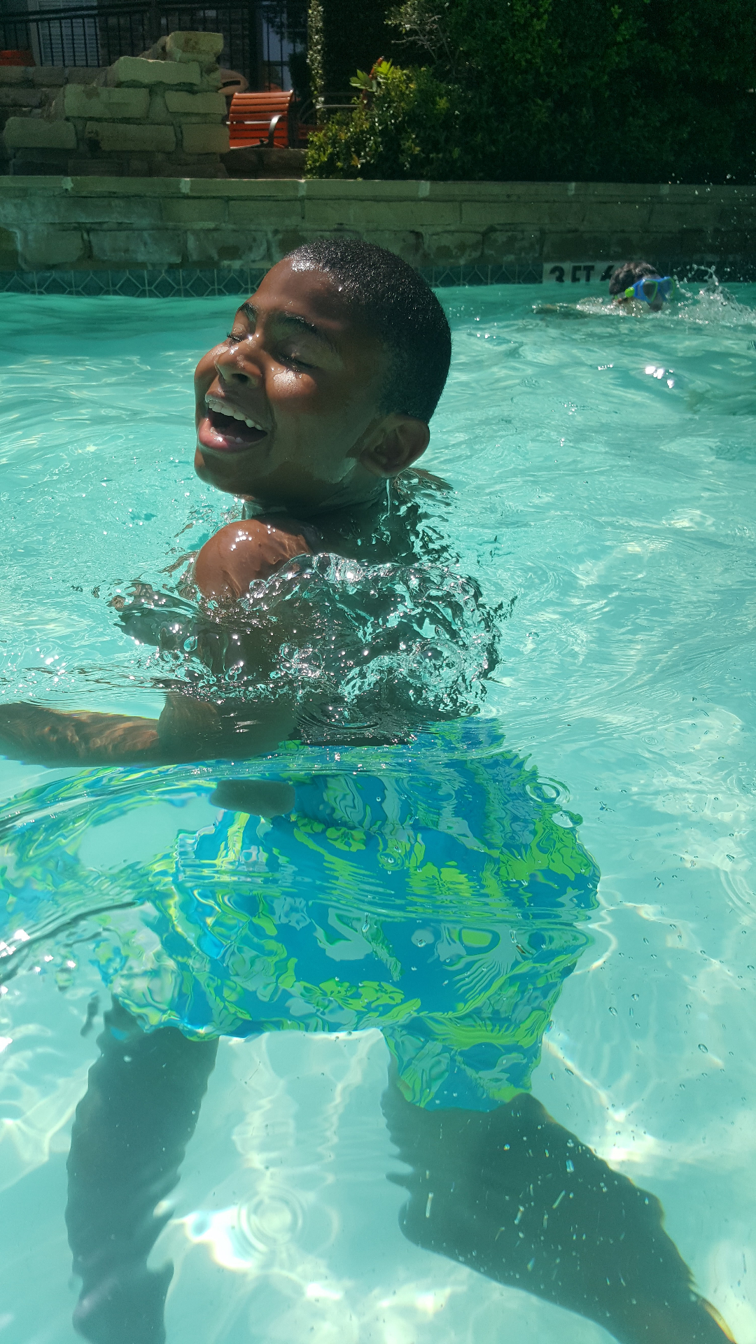 Jaiden laughing in the pool