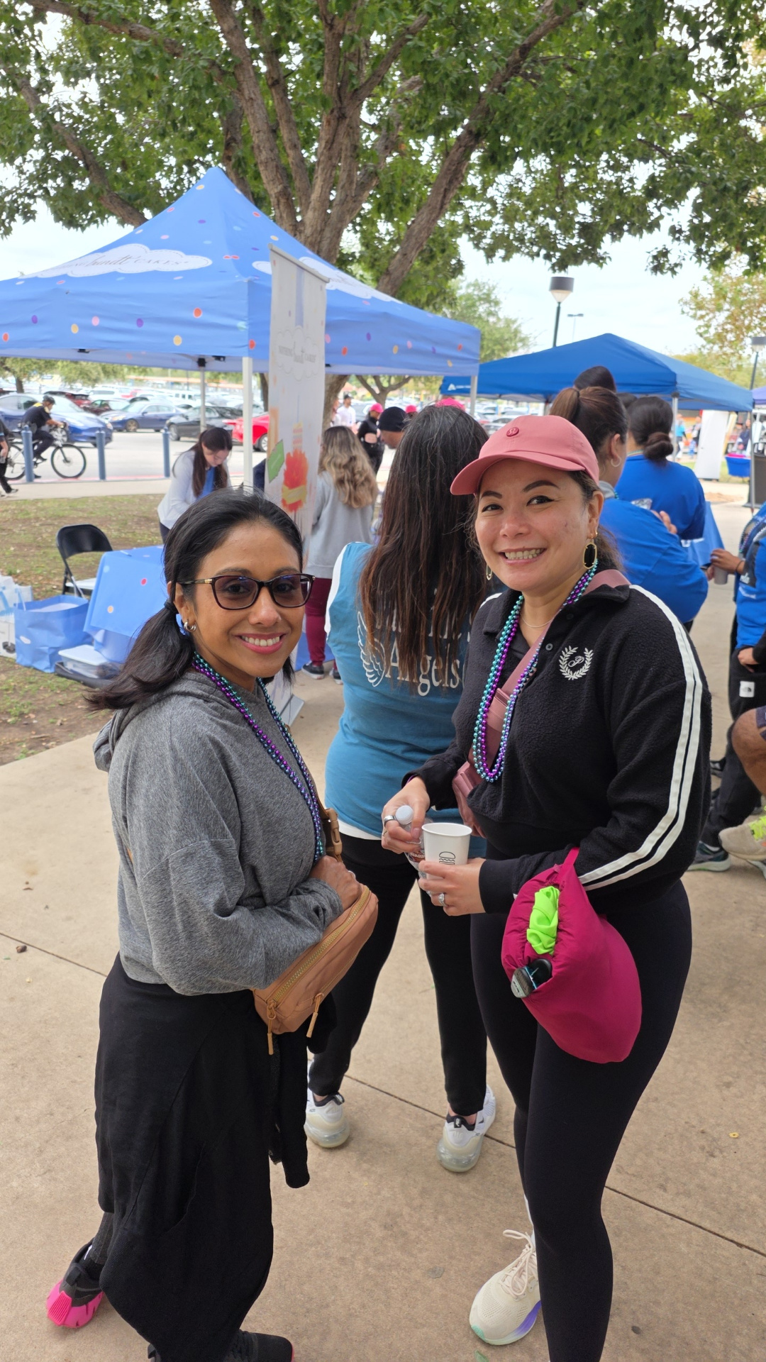 Two friends smiling at a community walk event