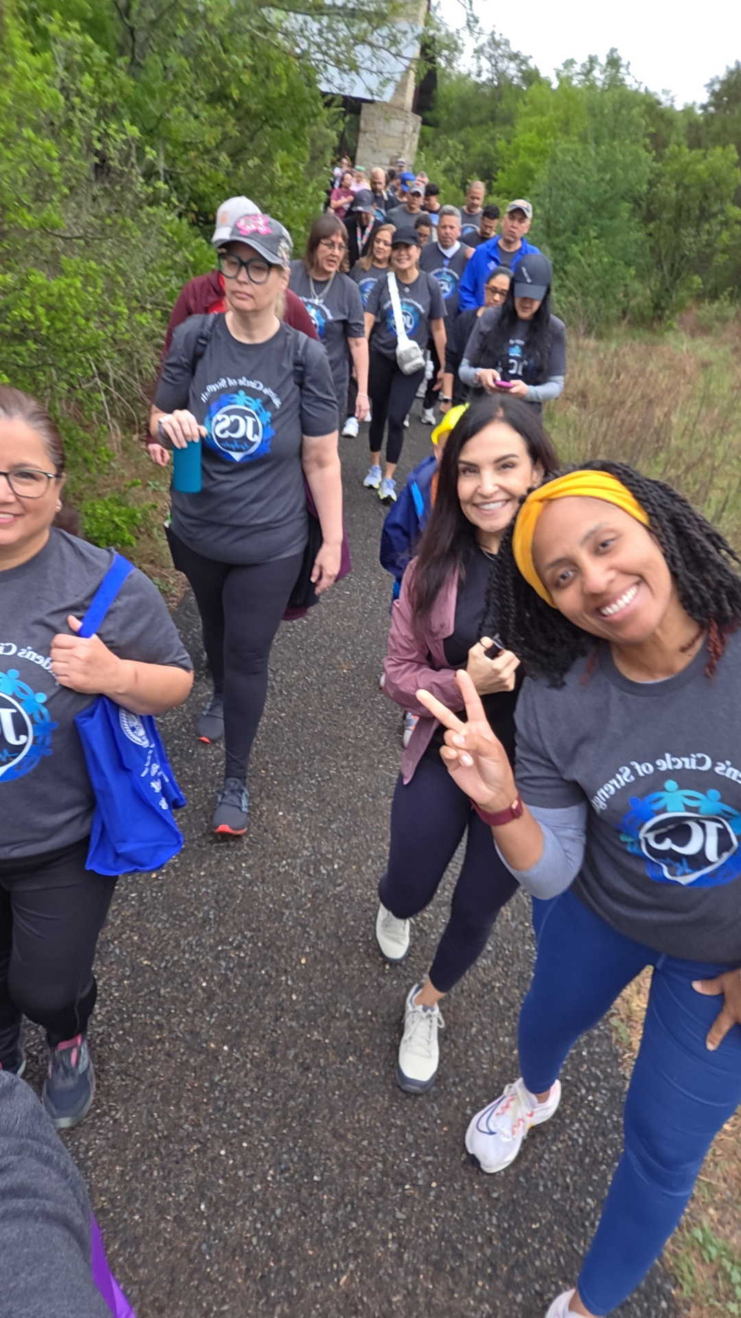 Supporters walking a trail together in JCS shirts