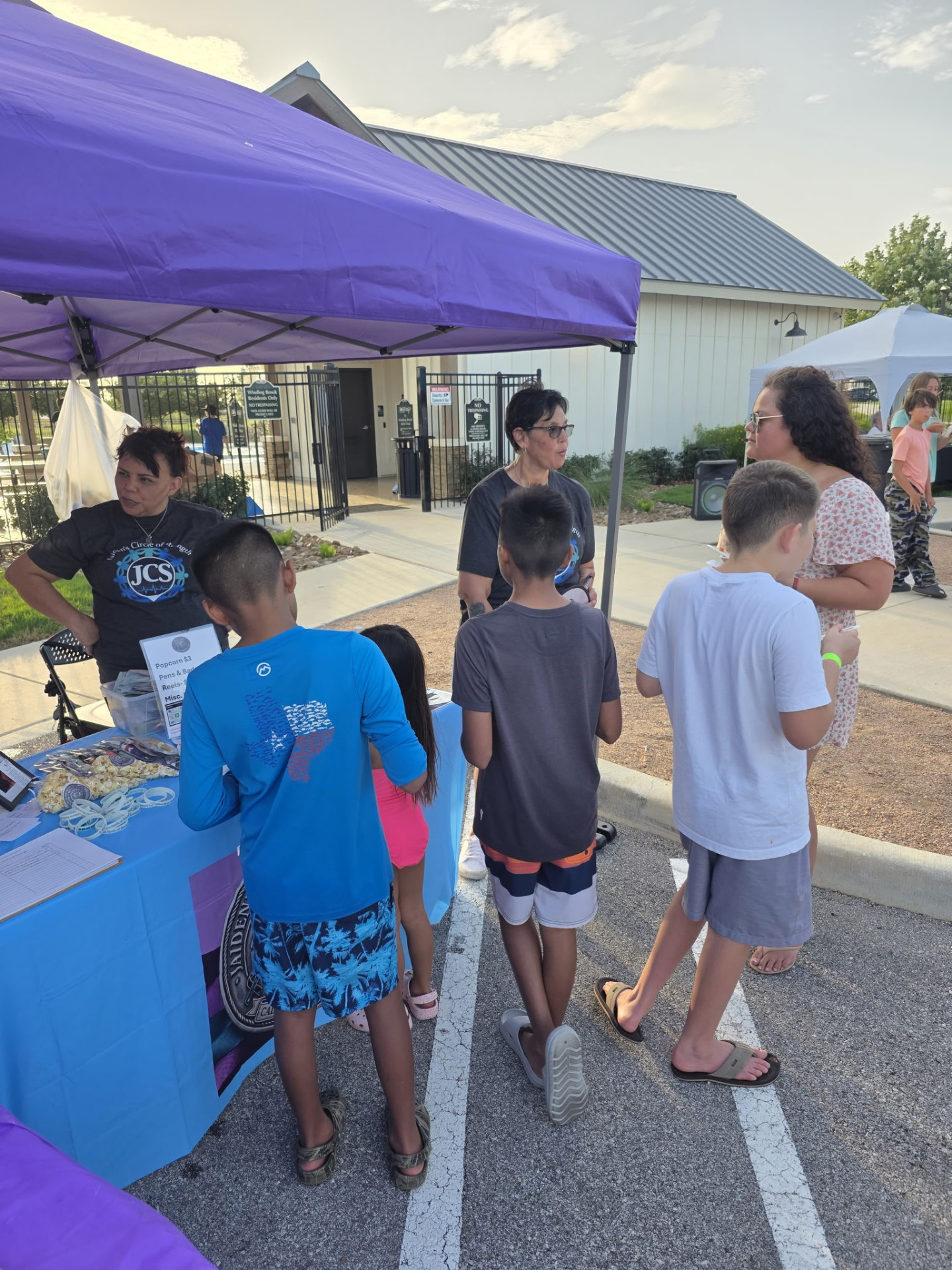 Families visiting the JCS booth at a community event