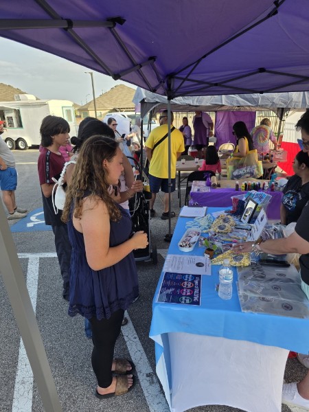 Visitors browsing items at the JCS outreach table